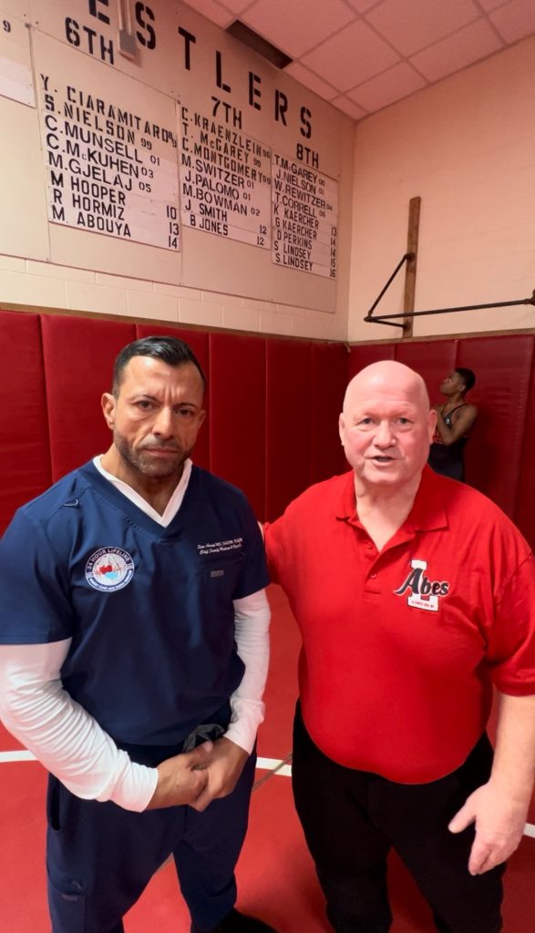 Dr. Awada with Warren Lincoln varsity wrestling head coach Ken Kaercher